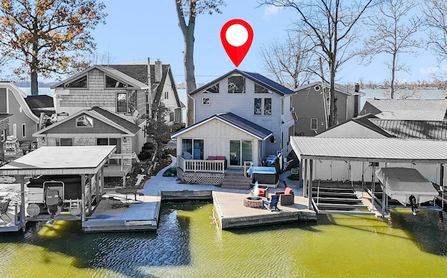 rear view of house featuring a water view