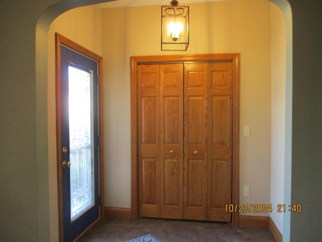 foyer featuring dark tile patterned flooring