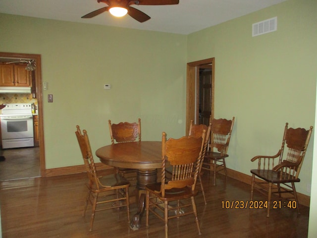 dining space with dark hardwood / wood-style floors and ceiling fan