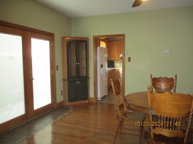 dining space featuring ceiling fan, wood-type flooring, and french doors