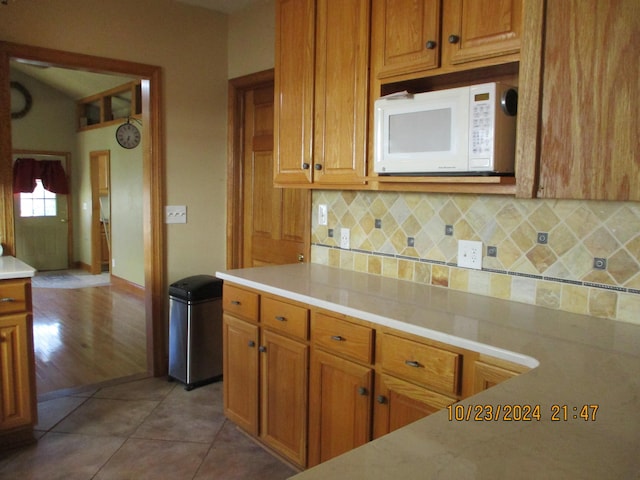 kitchen with decorative backsplash and light hardwood / wood-style flooring