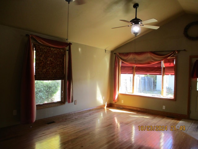 spare room featuring hardwood / wood-style flooring, vaulted ceiling, and ceiling fan