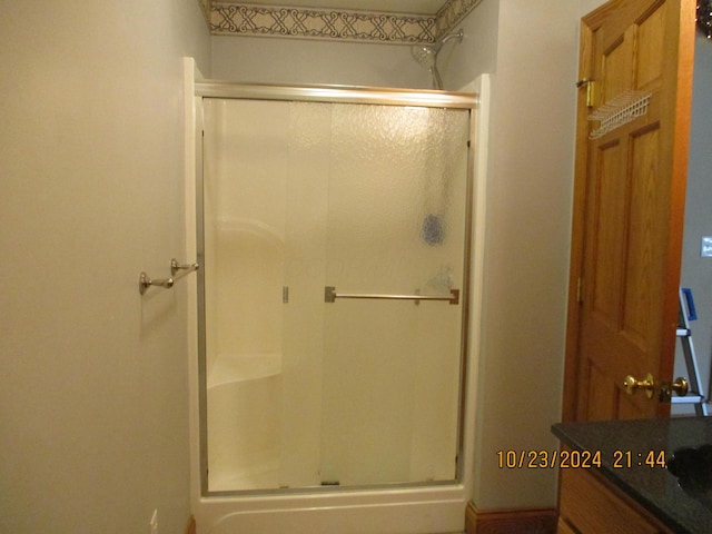 bathroom with vanity and a shower with shower door