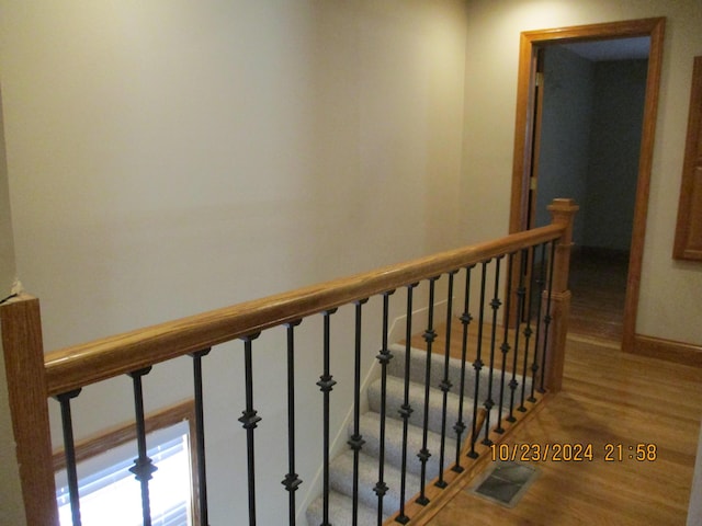 staircase with hardwood / wood-style flooring