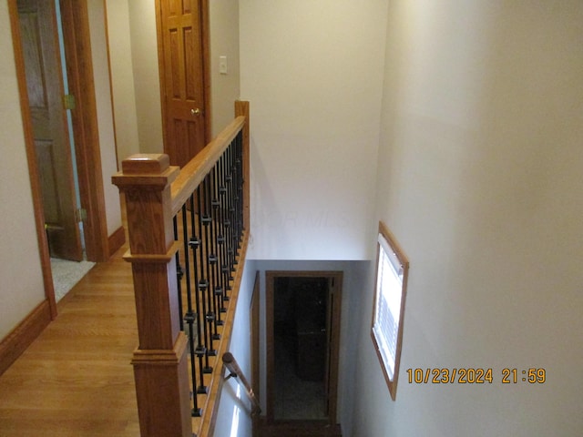 stairway with hardwood / wood-style floors