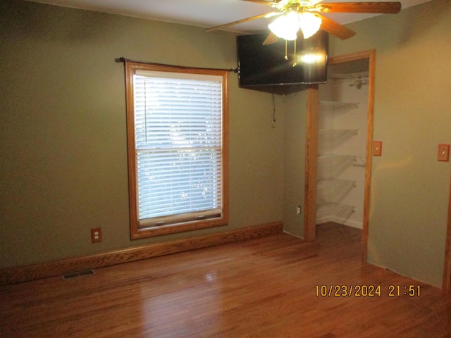 spare room featuring hardwood / wood-style floors and ceiling fan