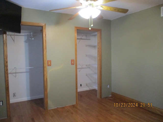 unfurnished bedroom with ceiling fan and hardwood / wood-style flooring