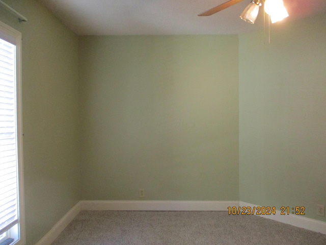 spare room with ceiling fan and carpet