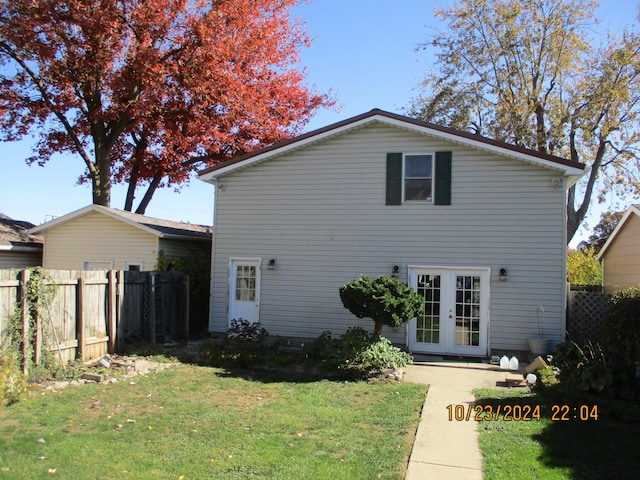 rear view of house with a yard and french doors