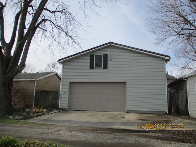 view of side of home featuring an outbuilding and a garage