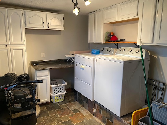 washroom with cabinets and washing machine and clothes dryer