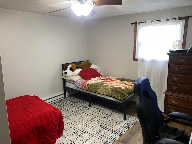 bedroom featuring hardwood / wood-style floors, baseboard heating, and ceiling fan