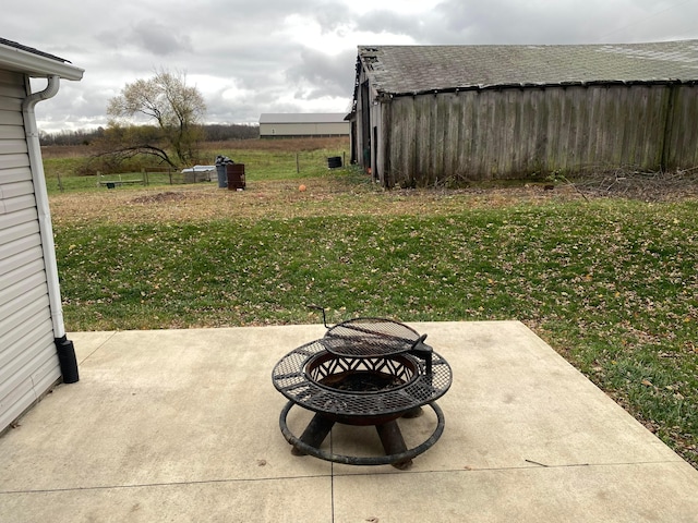 view of yard featuring a patio and an outdoor fire pit