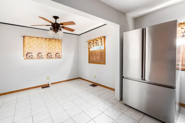 interior space featuring stainless steel fridge, crown molding, ceiling fan, and light tile patterned floors