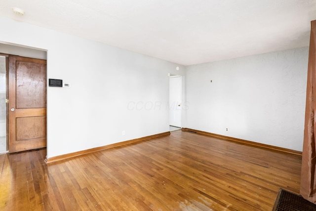 empty room with wood-type flooring