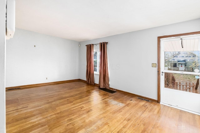 empty room with light hardwood / wood-style floors