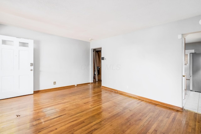 spare room with light hardwood / wood-style floors