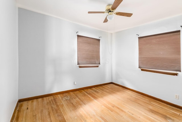 empty room featuring hardwood / wood-style flooring and ceiling fan