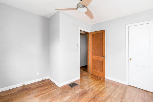 unfurnished bedroom with ceiling fan and light wood-type flooring