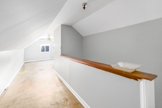 corridor featuring light hardwood / wood-style floors and vaulted ceiling