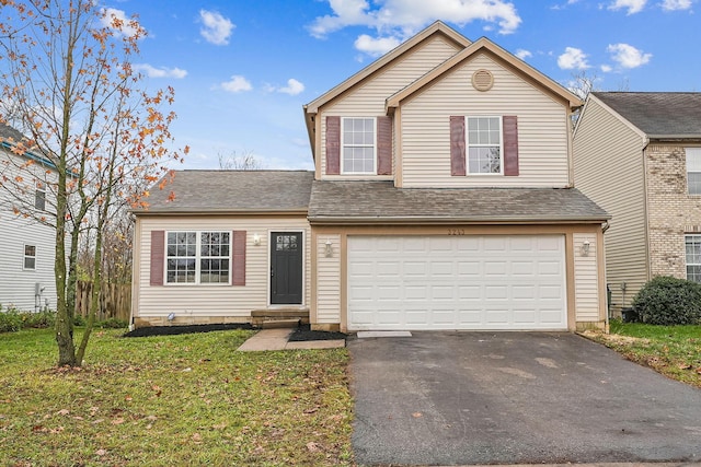 view of property with a garage and a front yard