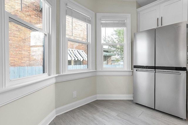 unfurnished dining area featuring light hardwood / wood-style floors