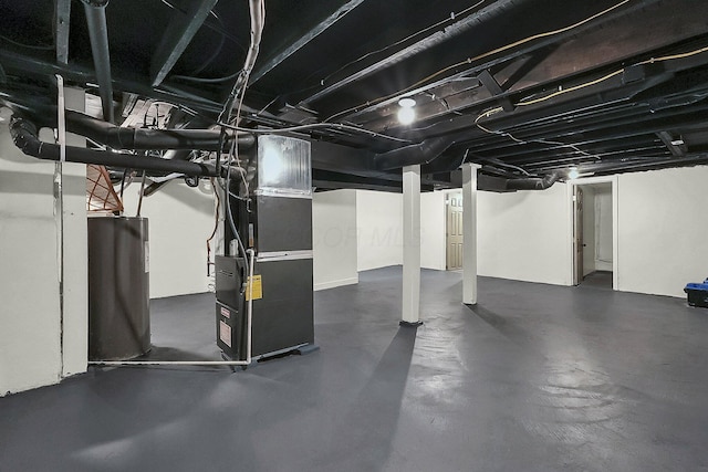 basement featuring heating unit and electric water heater