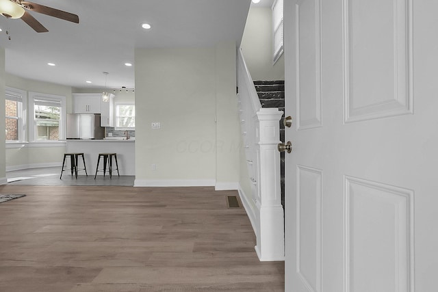 interior space featuring wood-type flooring and ceiling fan