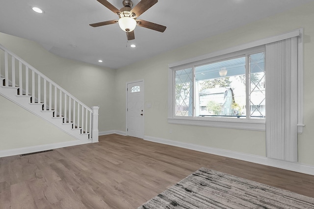 foyer entrance featuring ceiling fan and light wood-type flooring