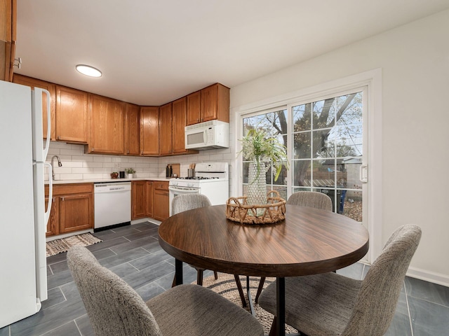 kitchen with white appliances, dark wood-type flooring, and tasteful backsplash