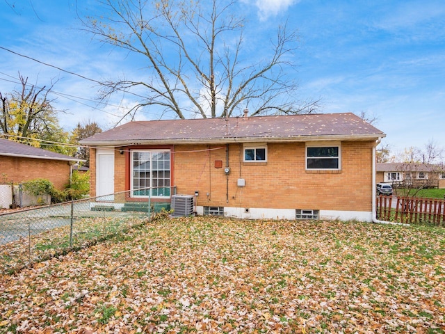 rear view of house featuring central air condition unit