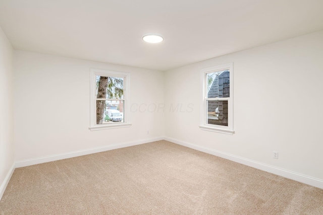 unfurnished room featuring carpet