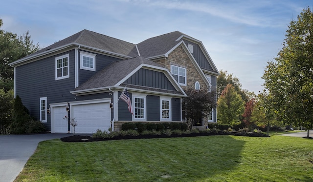 craftsman house with a front yard and a garage