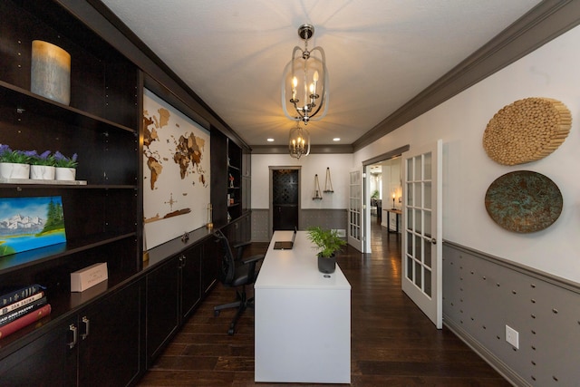 dining area with ornamental molding, french doors, dark wood-type flooring, and an inviting chandelier