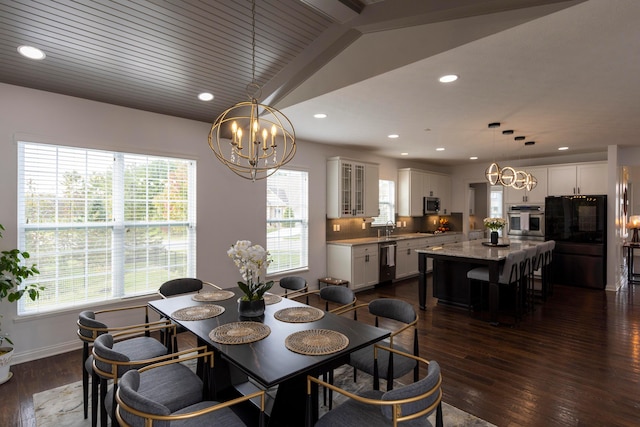 dining space featuring plenty of natural light, dark hardwood / wood-style flooring, and vaulted ceiling