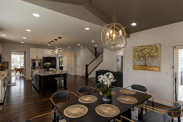 dining area featuring a chandelier, dark wood-type flooring, and lofted ceiling