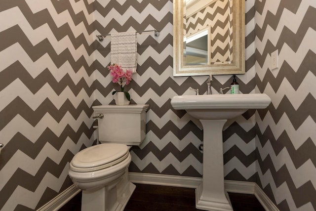 bathroom featuring hardwood / wood-style flooring and toilet