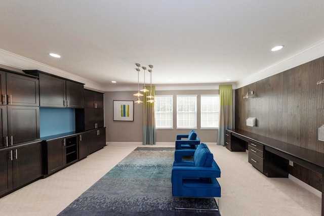 carpeted living room featuring built in desk and ornamental molding