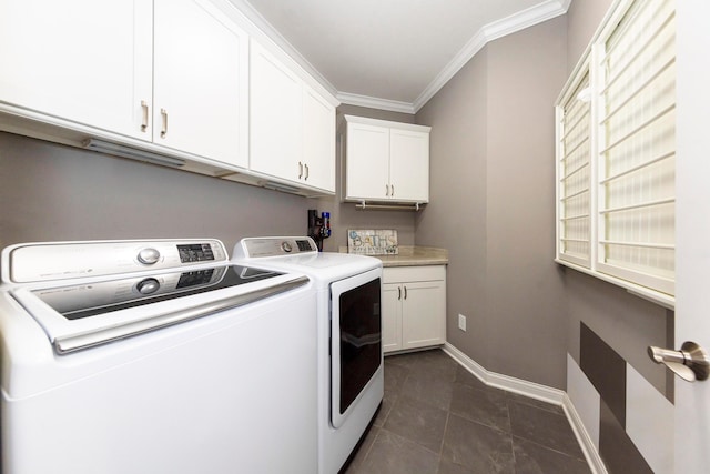 clothes washing area with ornamental molding, dark tile patterned floors, cabinets, and independent washer and dryer