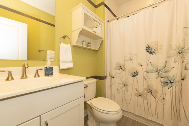 bathroom featuring wood-type flooring, vanity, a shower with shower curtain, and toilet