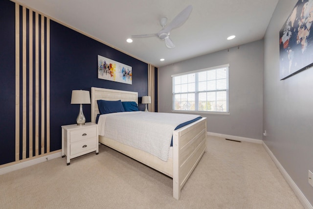 bedroom with ceiling fan and light colored carpet