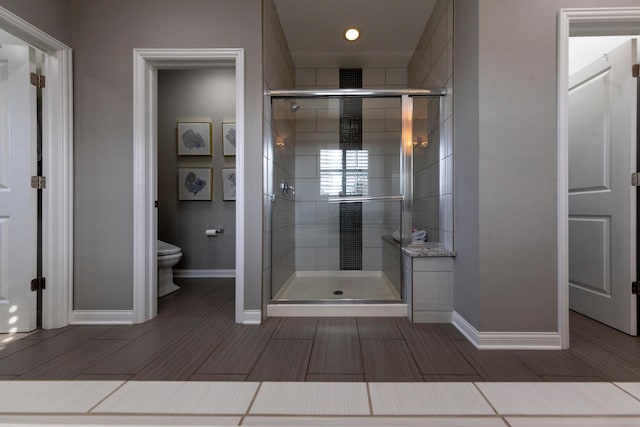 bathroom featuring toilet and walk in shower