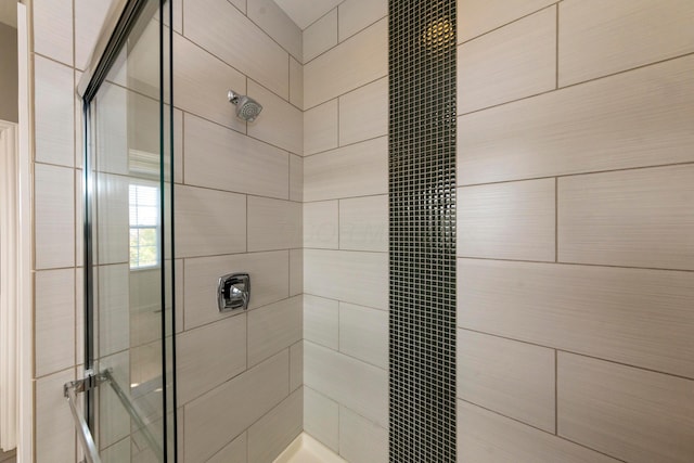 bathroom with a tile shower