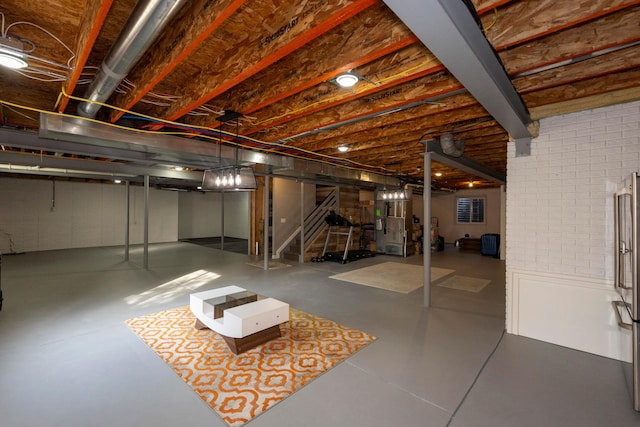 basement with heating unit and brick wall