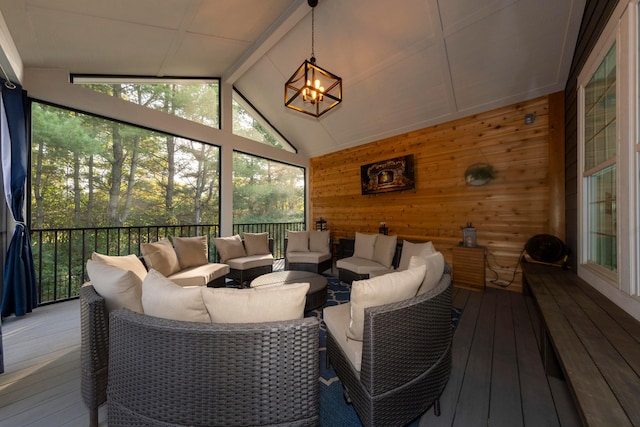 sunroom with vaulted ceiling with beams and a chandelier