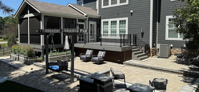 back of house featuring a sunroom, cooling unit, and a patio