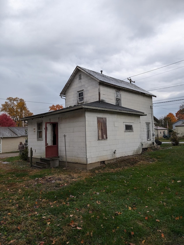 back of house with a yard