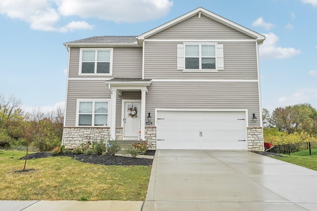 view of property featuring a front lawn and a garage