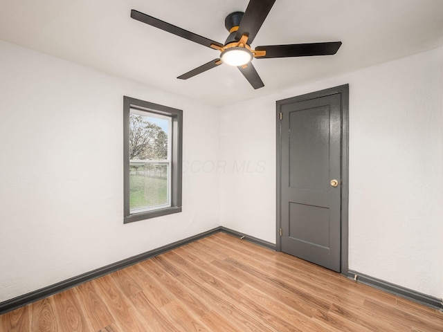 spare room featuring ceiling fan and light hardwood / wood-style flooring