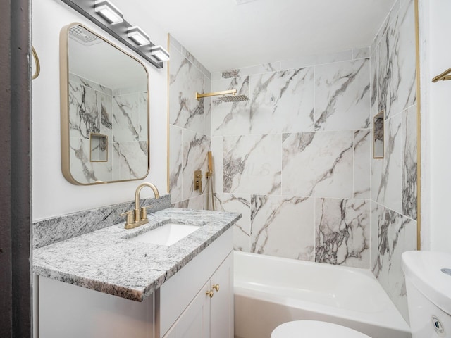 full bathroom featuring vanity, toilet, and tiled shower / bath combo